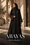 Femme portant une abaya noire brodée dans une galerie en pierre – Maison Layina